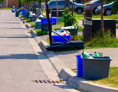 Recycling bins and cardboard baler in a sustainable rubbish area